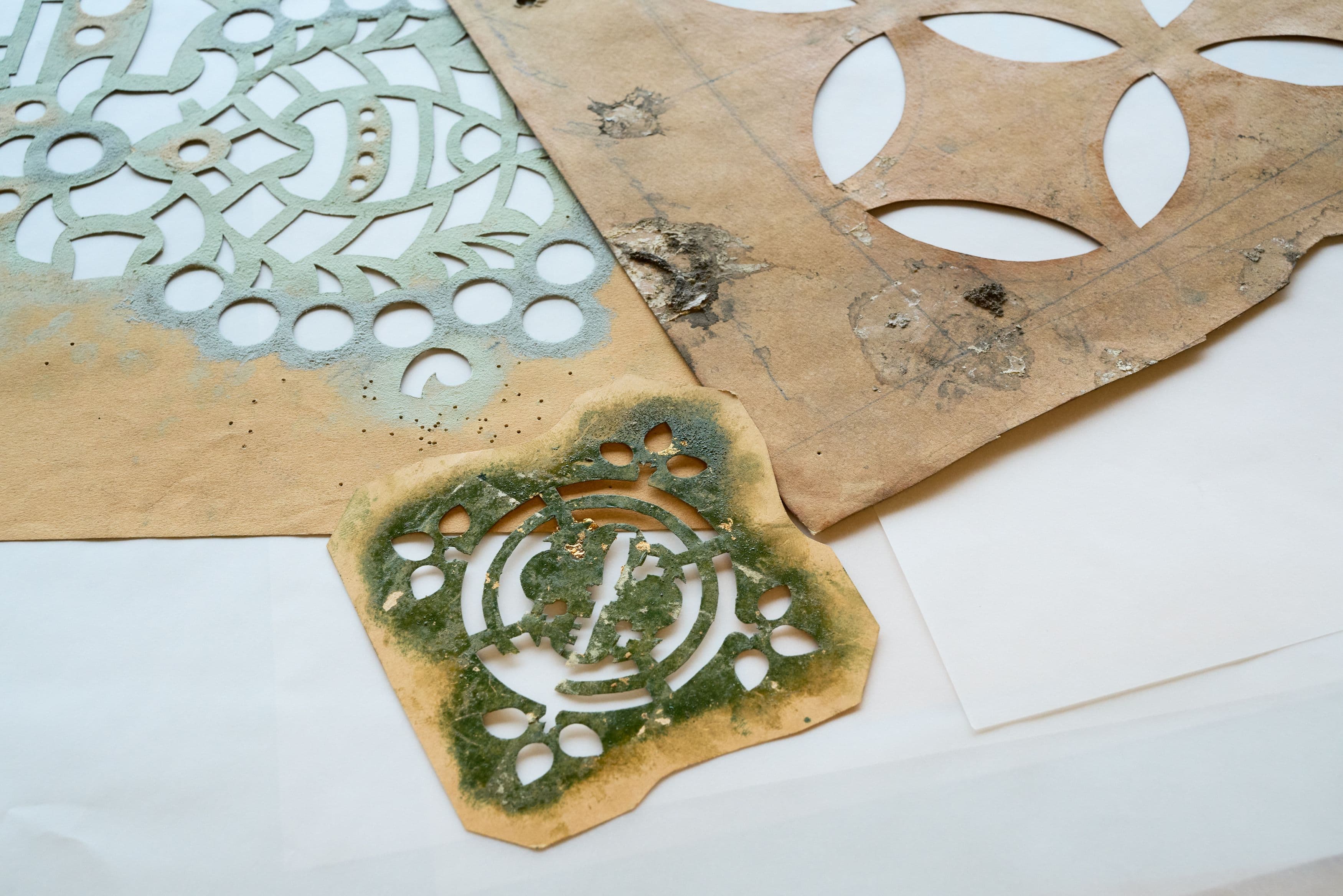 Stencils with remnants of gold leaf, bird droppings and punch-through holes. Collection Nieuwe Instituut, archive Kunstwerkplaats Cuypers & Co. Photo Johannes Schwartz.