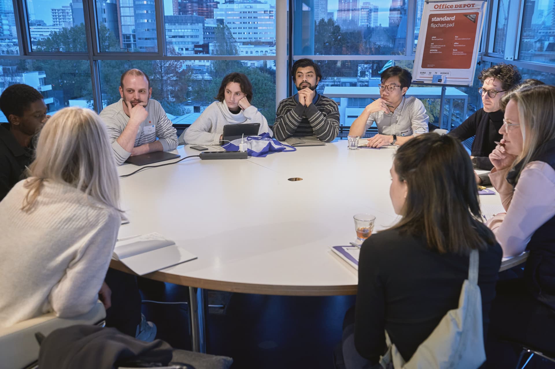 A group sitting at the table during an International Clinic in the Nieuwe Instituut